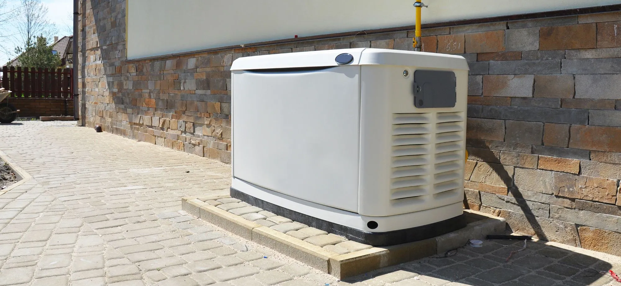 Standby whole-home generator installed on a pad beside a Hot Springs Village home
